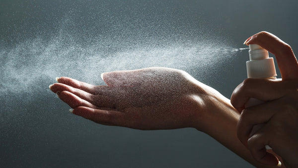 Hand being sanitized by HONA PureClean
